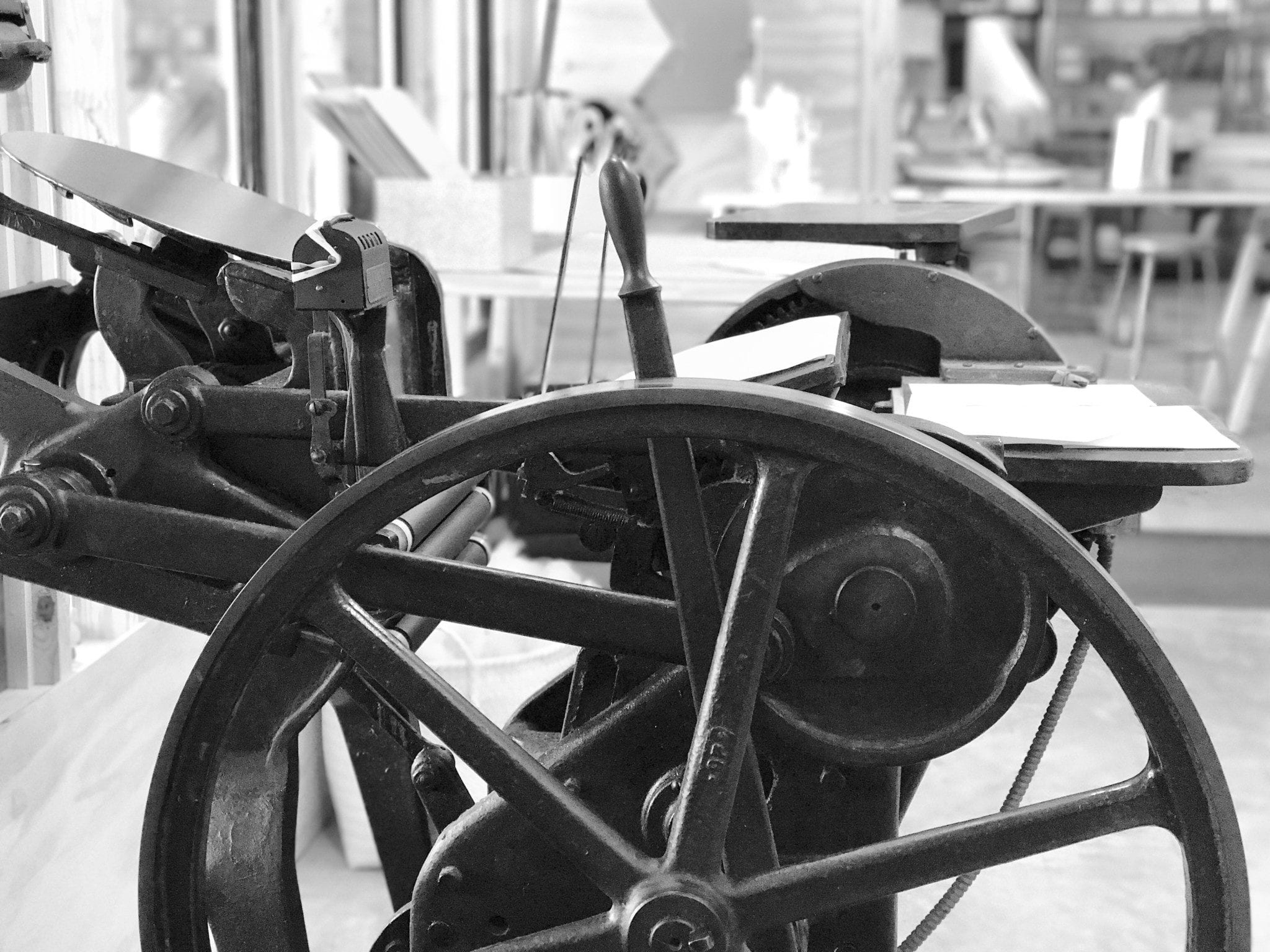 side view of letterpress printing machine showing flywheel