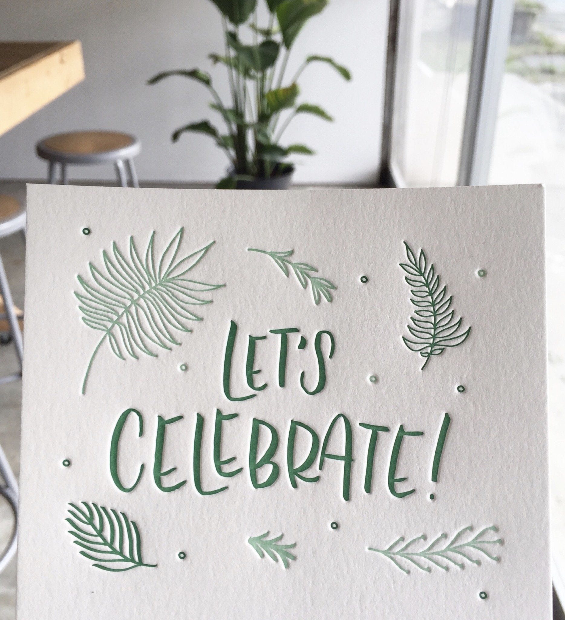 Let's Celebrate hand lettering with drawn fern elements