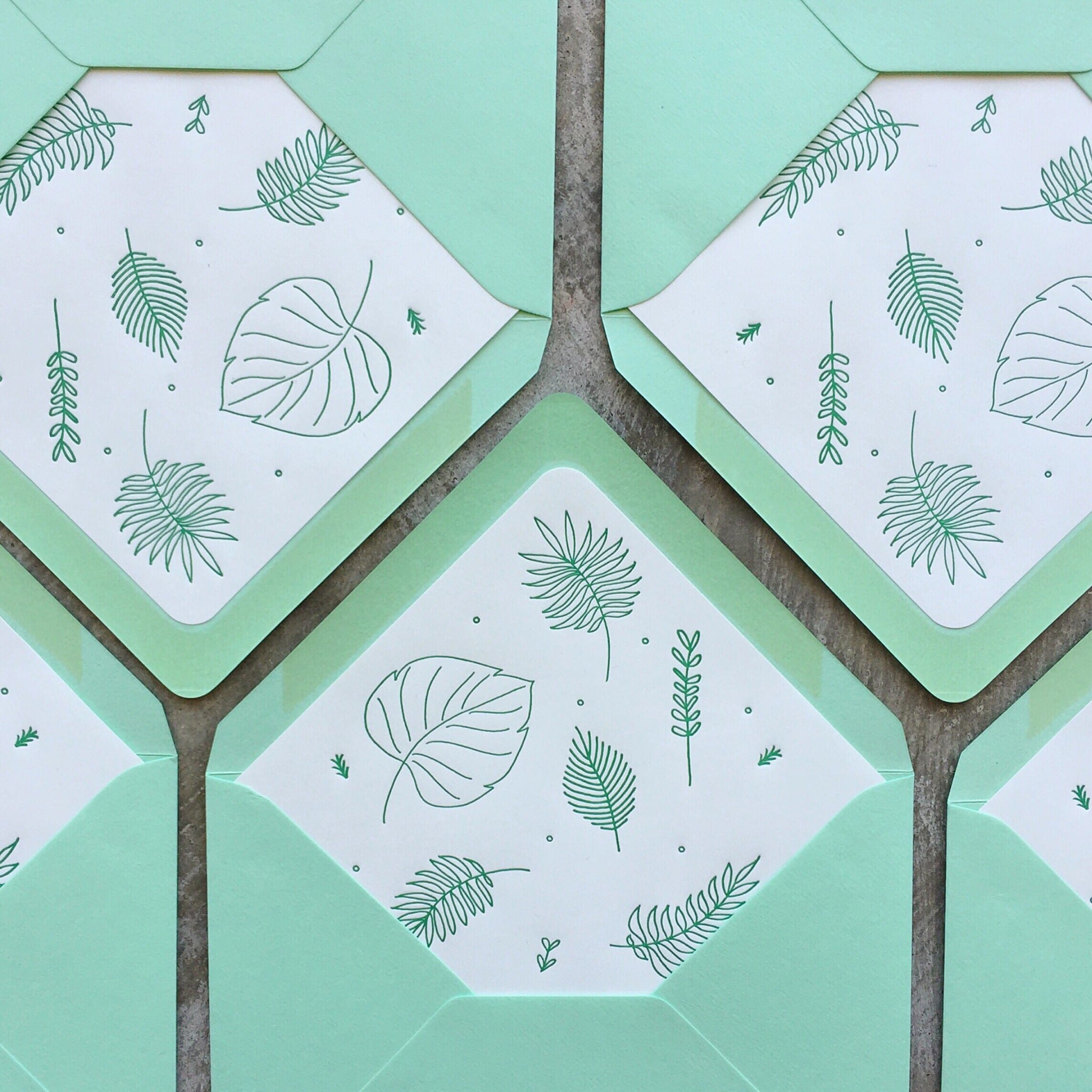 green envelopes with fern print