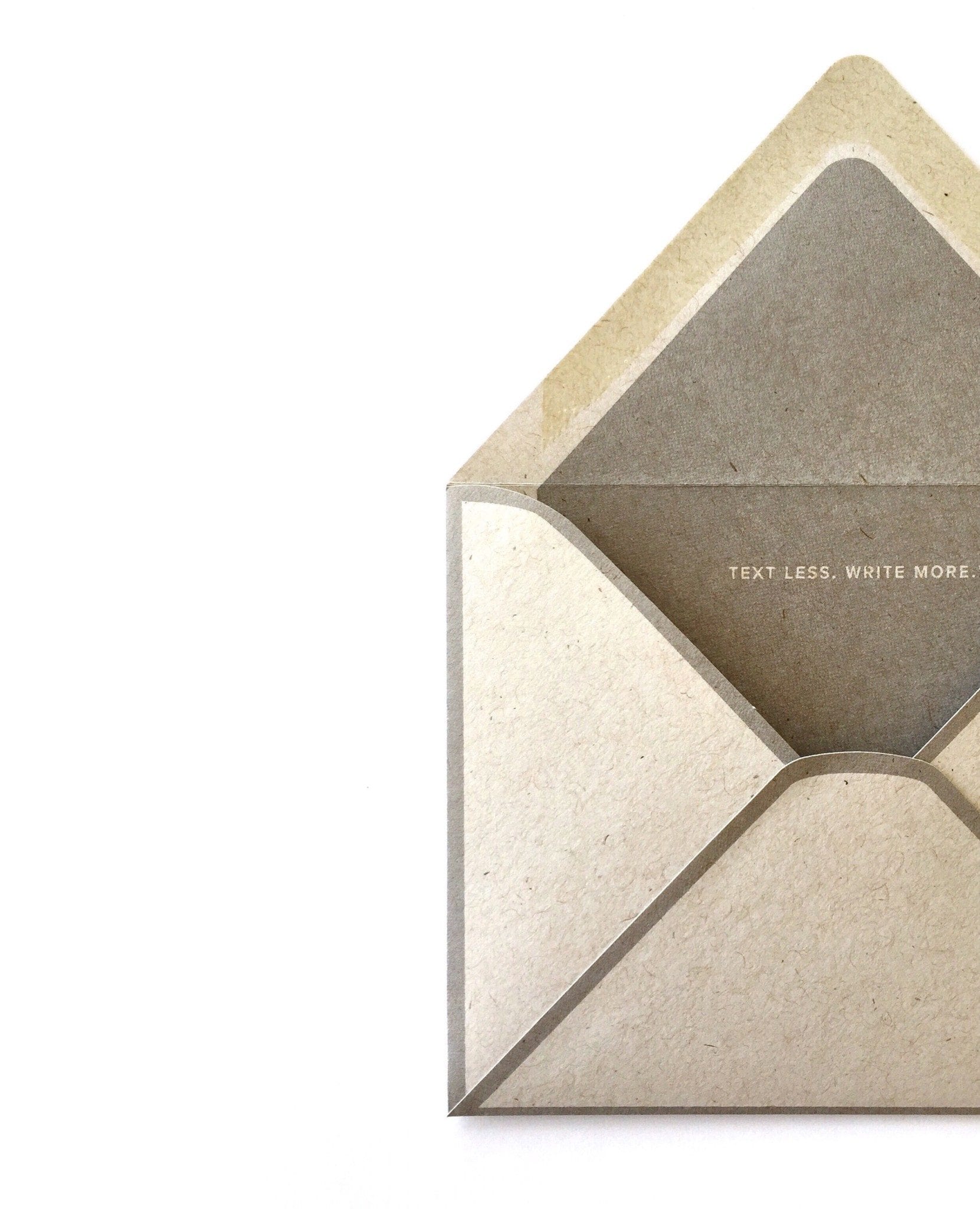 Gray kraft envelope with printed seems and a message on the interior liner, Text less. Write more.®