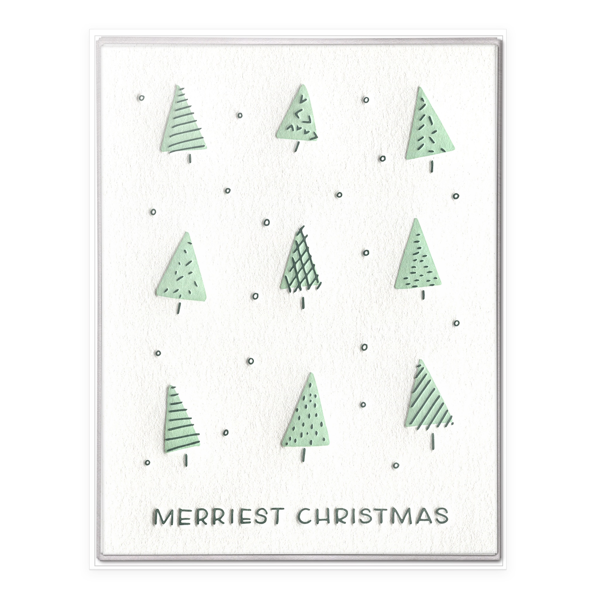 Boxed set of "Merriest Christmas" letterpress cards featuring nine whimsical green trees with varied patterns on textured white paper.