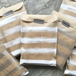 brown kraft paper bags painted with silver & white stripes and sealed with black & white striped washi tape