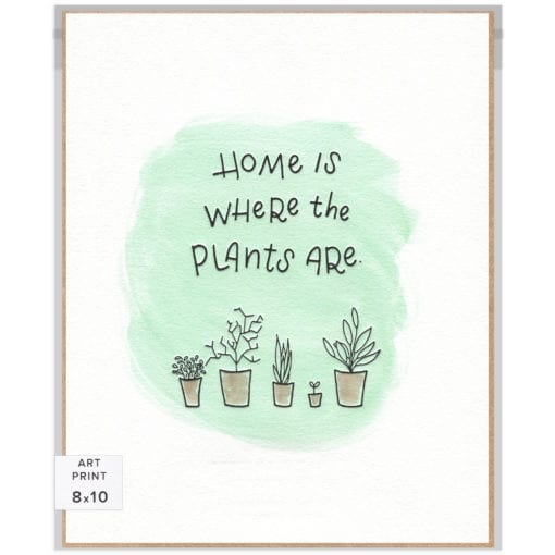 Handlettered words "Home is where the plants are" letterpress-printed in black with various hand-drawn plants in pots below. Supported by a unique green watercolor background.