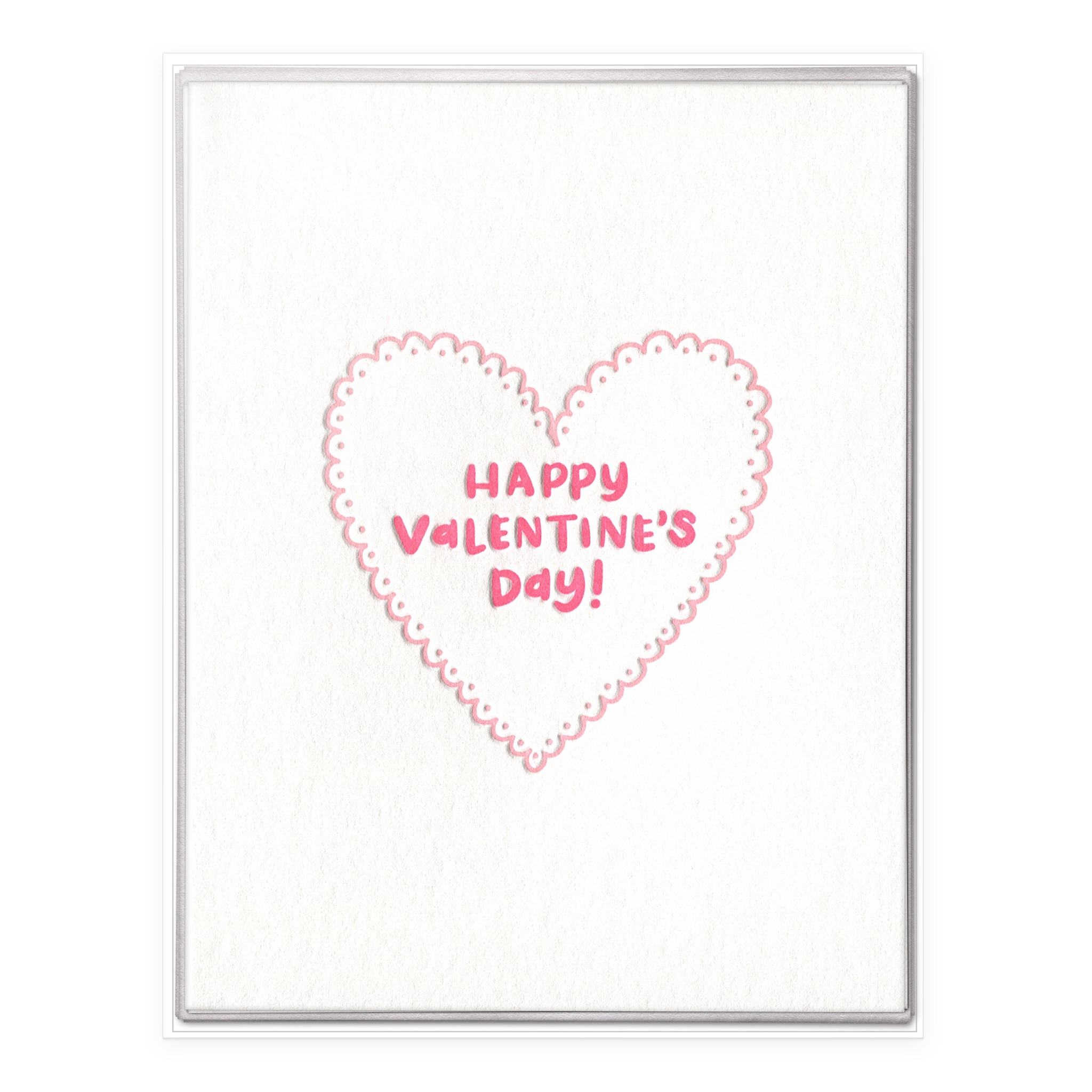 Letterpress "Happy Valentine's Day!" boxed set card with pink scalloped doily heart displayed with six gray envelopes.